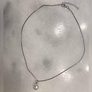 White pearl pendant necklace on silver adjustable chain